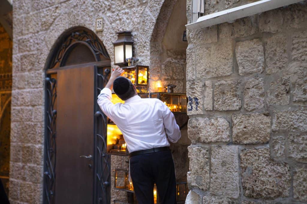 Ein Jude entzündet an seinem Haus in Jerusalem die Chanukka-Kerzen in einer Laterne